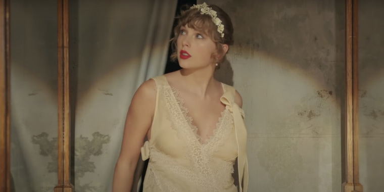 Taylor Swift wears a lacy ivory dress in the new music video for “Willow,” and it has her fans wondering if it’s really a wedding gown.