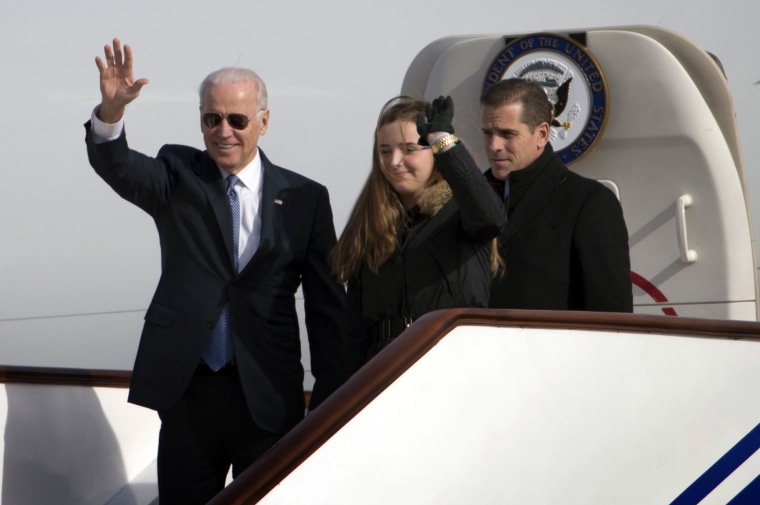 Image: Vice President Joe Biden waves as he arrives in Beijing with his granddaughter, Finnegan, and son, Hunter, on Dec. 4, 2013.