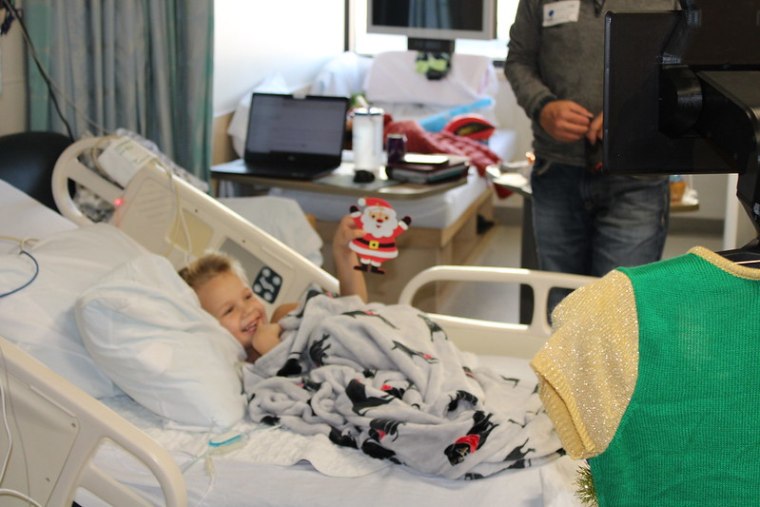 Visiting with Santa, Mrs. Claus, a reindeer and elf brightened the moods of many children in St. Louis Children's Hospital.