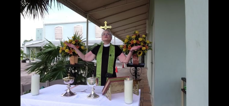 Mother Leslie leads a parking lot service at All Saints Episcopal Church in Fort Lauderdale, Florida on December 12, 2020.