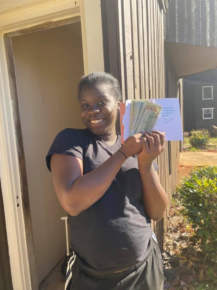 Bryanna poses with cash donations she received from kind-hearted social media users.