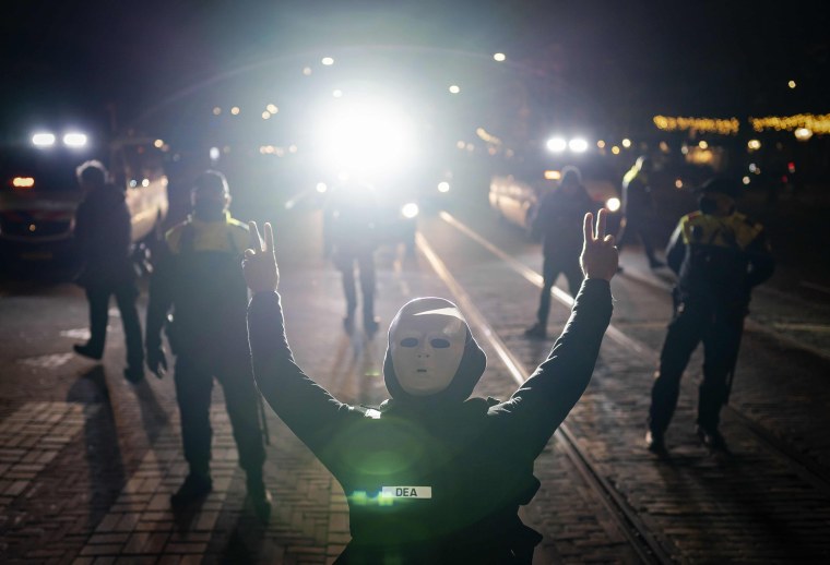 Image: People demonstrate outside the Torentje, the office of prime minister, during his speech announcing a five-week national lockdown in The Hague.