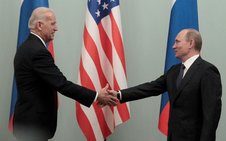 Image: Russian Prime Minister Vladimir Putin shakes hands with Vice President Joe Biden during their meeting in Moscow