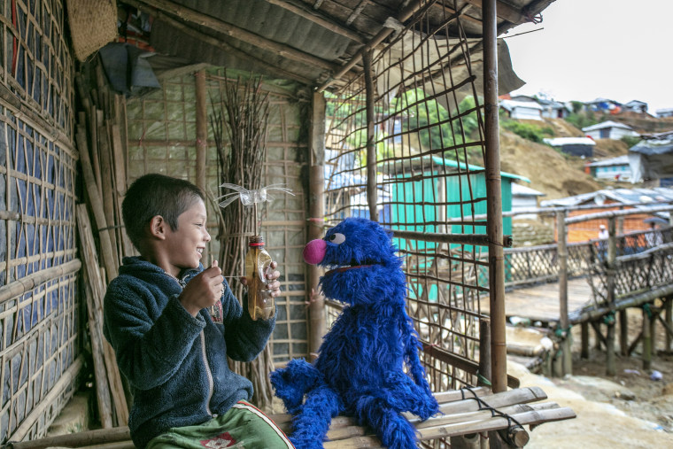 Grover plays with a Rohingya child in the Kutapalong camp in Cox's Bazar, Bangladesh. Sesame Workshop believes that if they invest in reaching young children in humanitarian settings, the children will have a chance to succeed and that can change the word.