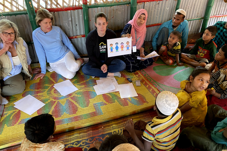 Kim Foulds, the senior director for international research at Sesame Workshop, leads a research session with Rohingya children and their fathers to gain input on which characters the children feel most comfortable with and identify with the most.