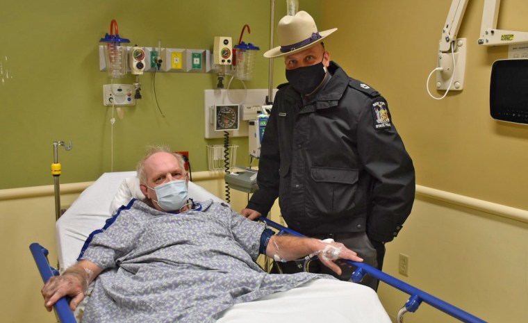 Sgt. Jason Cawley with the driver he discovered trapped in his vehicle by heavy snow in Owego, N.Y.