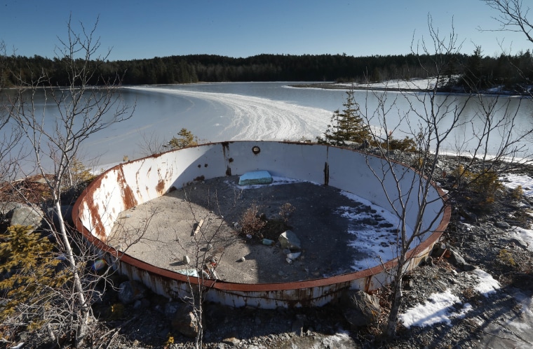 A deteriorating tank sits on the site of the Callahan Mine in Maine in 2016. The former open pit copper and zinc mine is a federal Superfund site.