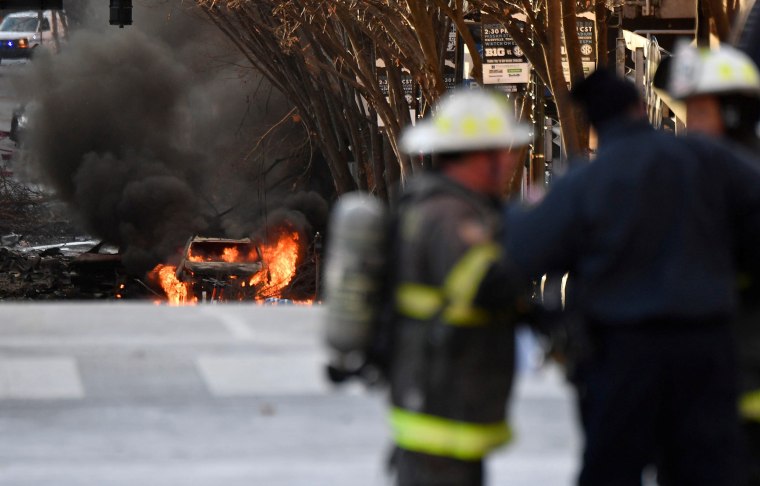 Image: A vehicle burns near the site of an explosion in the area of Second and Commerce in Nashville