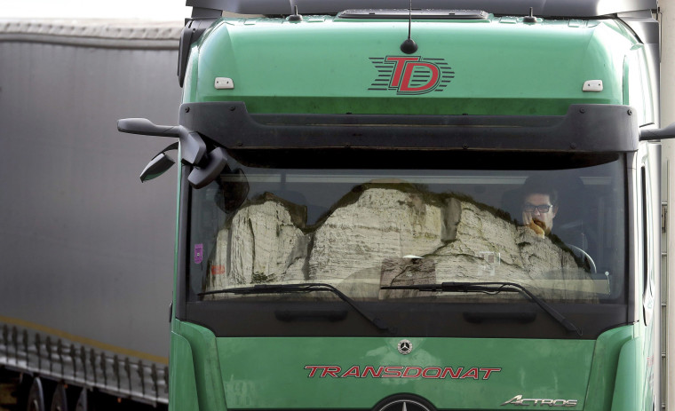 Image: The iconic White Cliffs of Dover, which stand outside England's main ferry port, are reflected in the windscreen of a truck on Saturday.