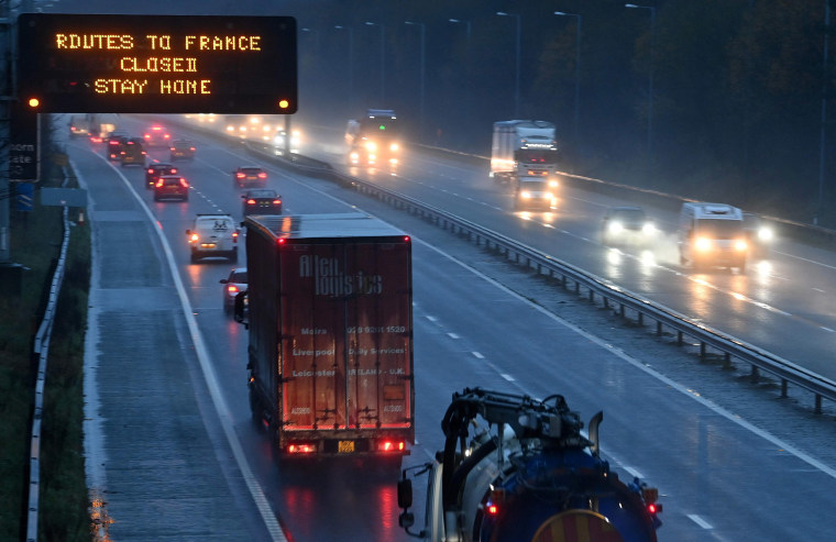 Image: A sign on the M56 motorway informs drivers that all routes into France are closed at the junction with the M6 at Lower Stretton near Warrington, northwest England