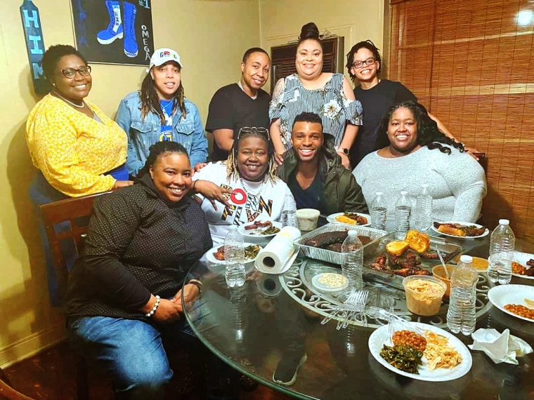 Tanyun Monta'ge, center back row, the patriarch of "The House of Monta'ge," enjoys a meal with his "chosen family" in Jackson, Miss.