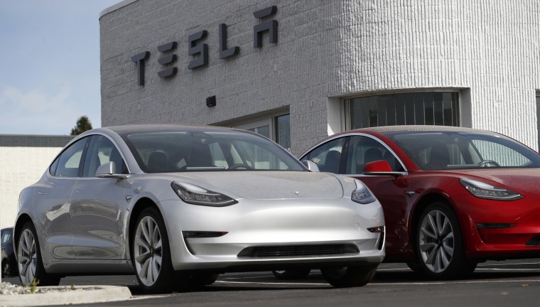 Image: Model 3 Long Range vehicles sit on a Tesla dealer's lot in the south Denver suburb of Littleton, Colo.