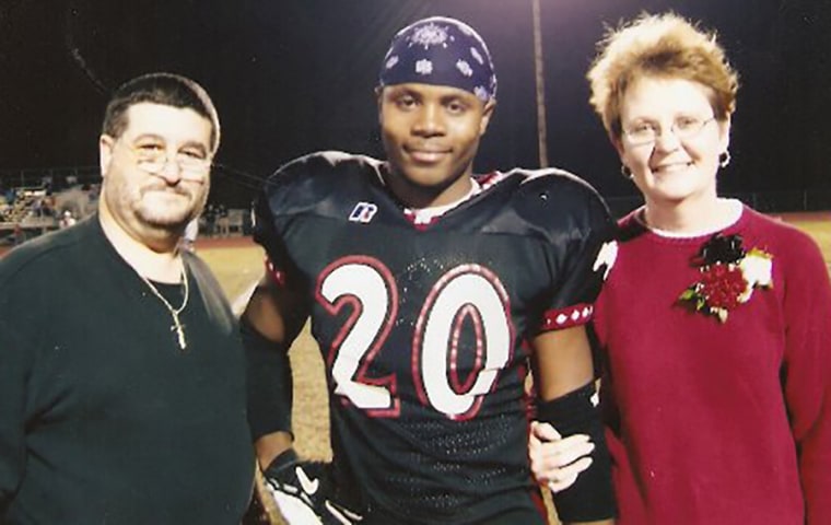 Darrion Cockrell with Dennis Kaeser, his middle school football coach, and Kaeser's wife. The couple eventually became his foster parents.