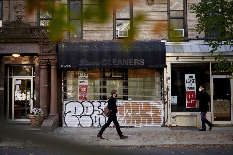 Pedestrians pass an empty storefront in New York on Nov. 19, 2020.