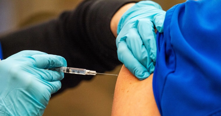 Image: A healthcare worker getting a vaccine