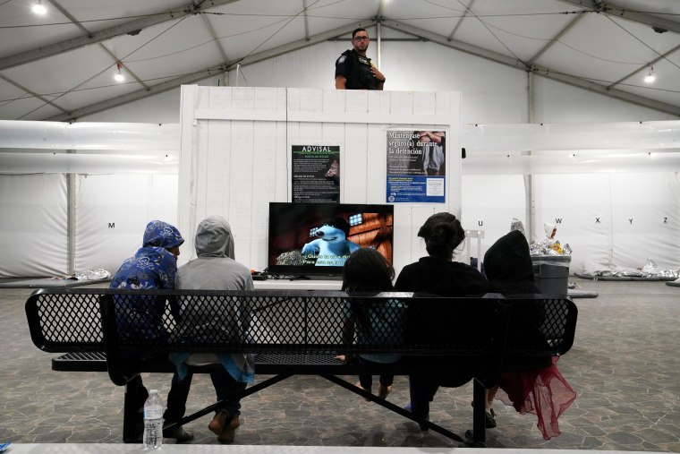 Image: Young asylum-seekers watch a movie at the Donna Soft-Sided Processing Facility