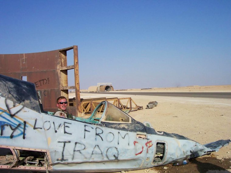 Man in military uniform sitting in a parked plane