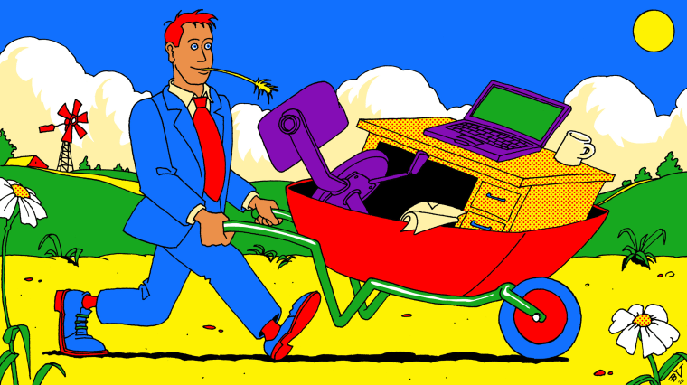 Image: A man wearing a suit pushes a wheelbarrow filled with his desk, chair and computer across a rural farm field.