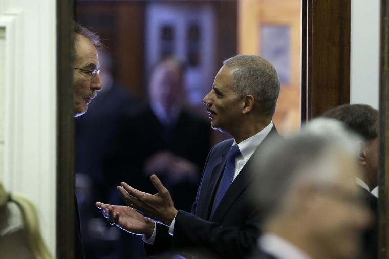 Image: Attorney General Eric Holder talks with U.S. District Judge Robert Pratt, left, in Des Moines, Iowa.