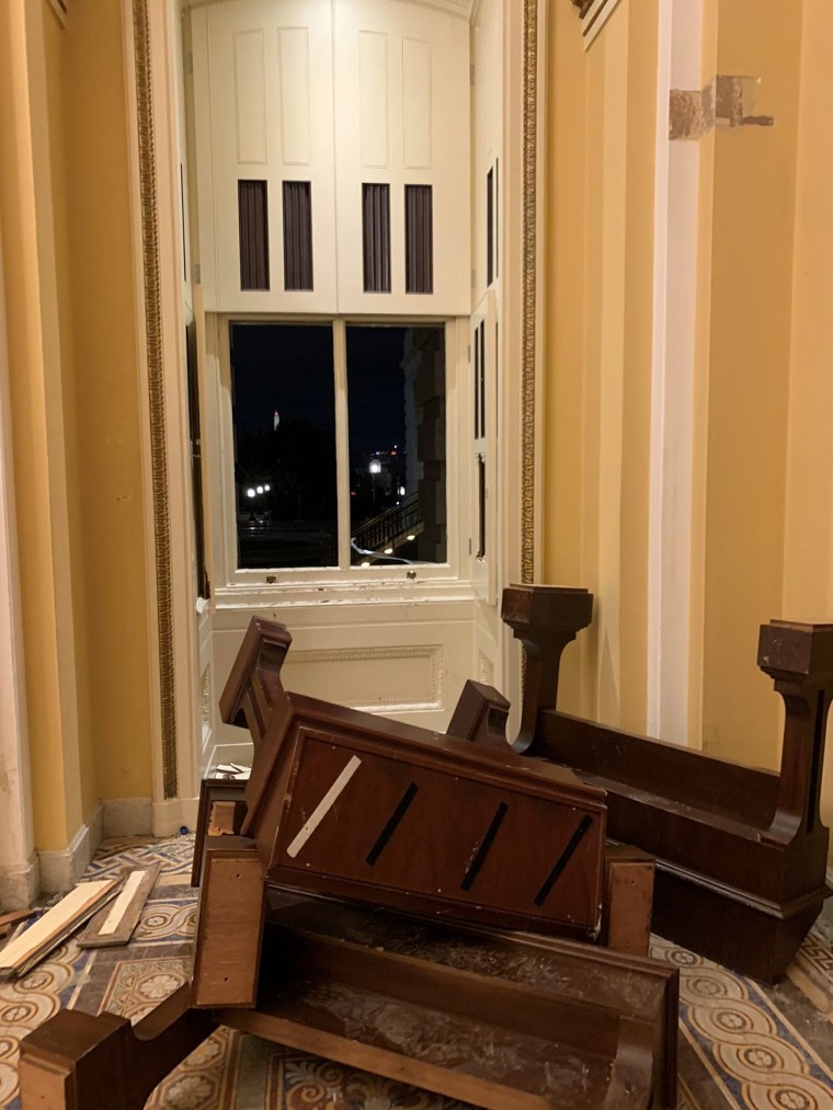 Image: Flipped furniture and a broken window glass lie on the floor inside the U.S. Capitol in Washington