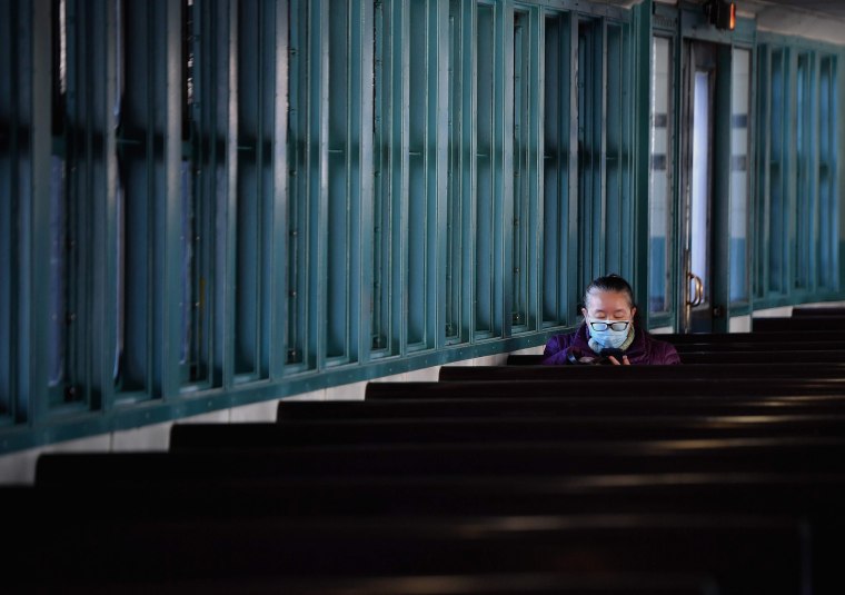 Image: A person sits alone while commuting on the Staten Island Ferry amid the coronavirus pandemic