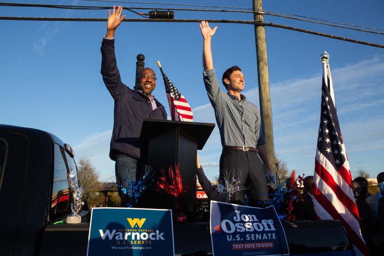 Image: Democratic U.S. Senate candidates Jon Ossoff and Raphael Warnock of Georgia wave to supporters during a rally on in Marietta, Ga.
