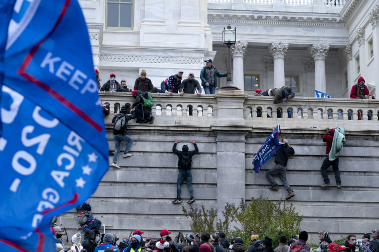 Image: Protesters climb Capitol wall 