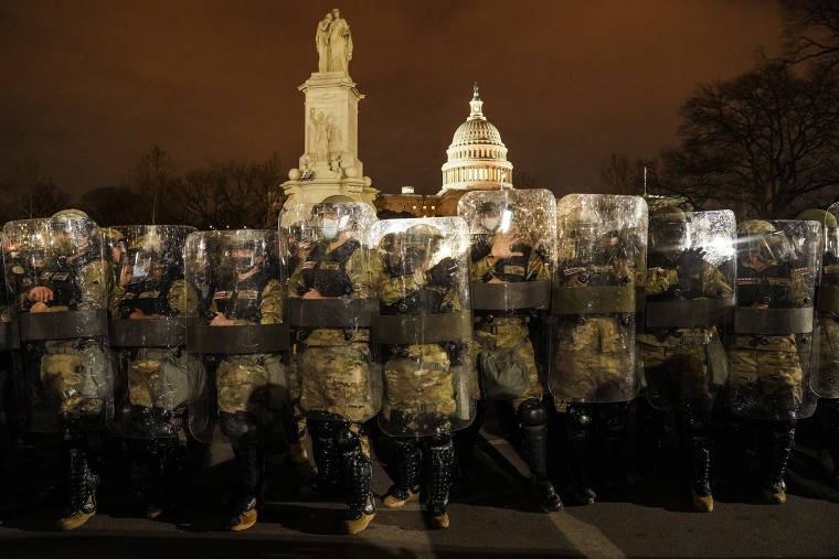 Image: District of Columbia National Guard stand outside the Capitol, Wednesday night, Jan. 6, 2021, after a day of rioting protesters.