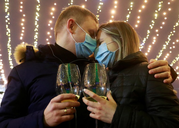 Image: A couple embrace during New Year's day celebrations in Kyiv