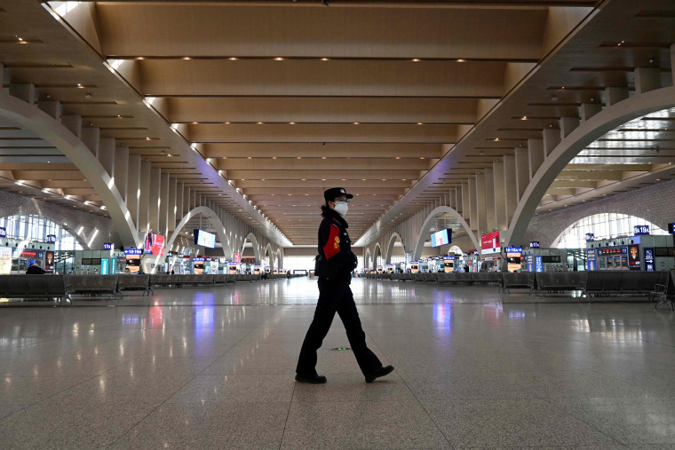 Image: A police patrol walking at an empty railway station as the city cuts outside transport links and bans residents from leaving, after the largest domestic Covid-19 coronavirus outbreak in six months in Shijiazhaung, in northern China's Hebei province