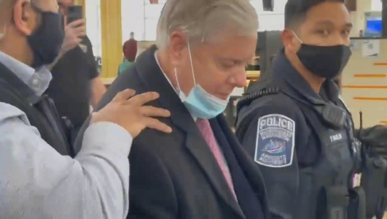 Image: Social media video grab of U.S. Senator Lindsey Graham being escorted by security personnel as Trump supporters berate him, at Reagan National Airport in Washington