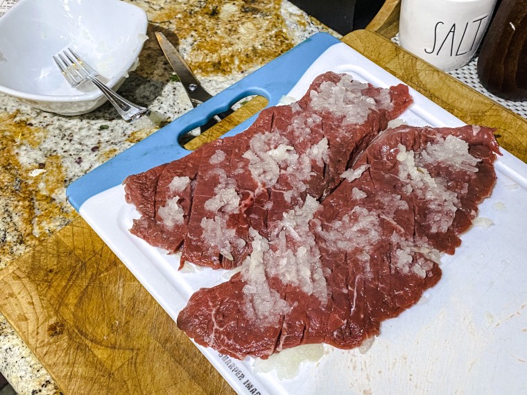 Pounded steak is marinated in grated onion to make it as tender as possible.