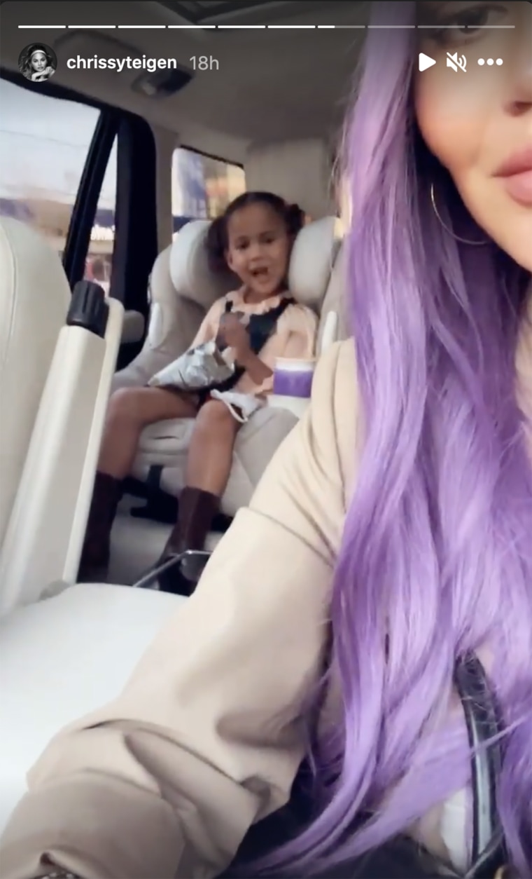 The mom of two shared a video of her driving in her lavender wig as 4-year-old daughter Luna sits behind her. 