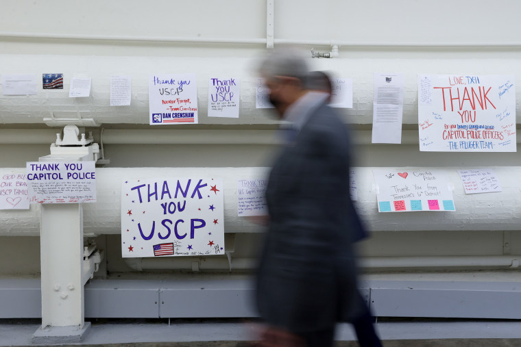 Image: Members of the U.S. House of Representatives walk past signs and posters expressing support and thanks for U.S. Capitol Police officers at the Capitol in Washington