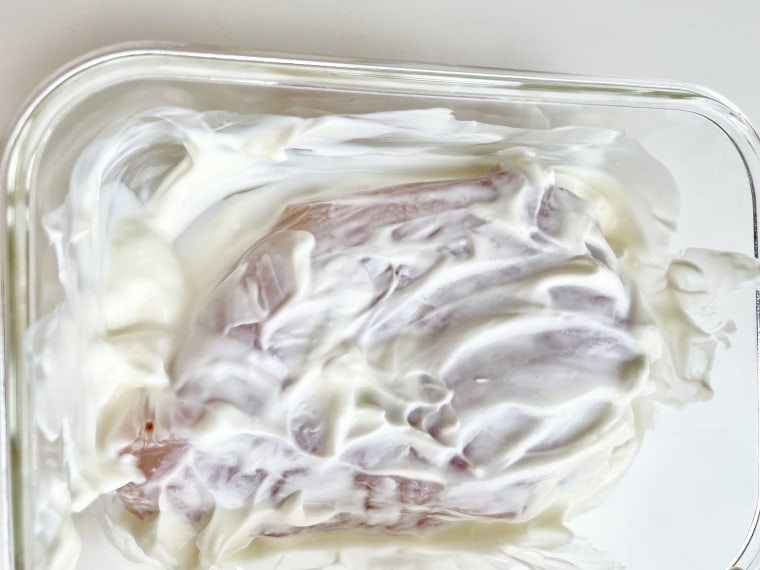 The lactic acid in the yogurt tenderizes the chicken breast.