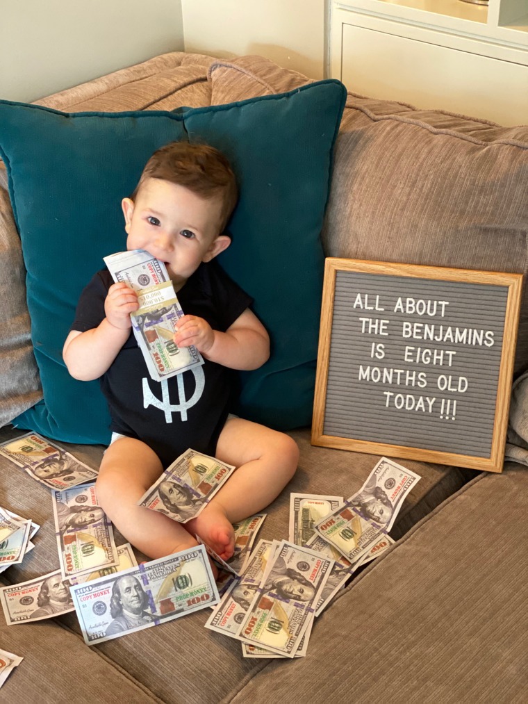 Baby Ben Schwartz photographed with cash and an "All about the Benjamins" sign