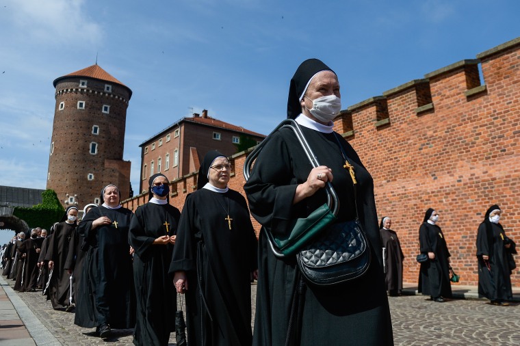 Image: Nuns wear protective face masks as they take part in a collective mass on Krakow's Wawel Castle