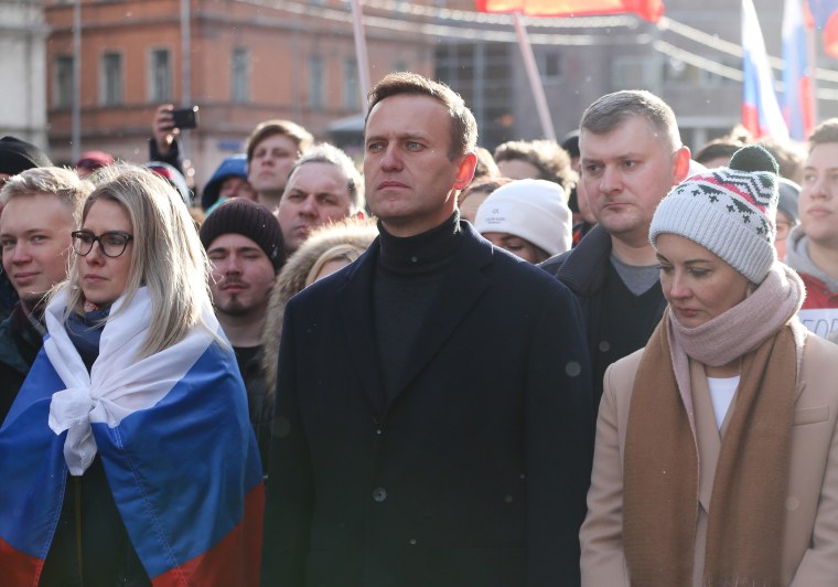 Image: Alexey Navalny, Russian opposition leader, center, and his wife Yulia, right, walk with demonstrators during a rally in Moscow.