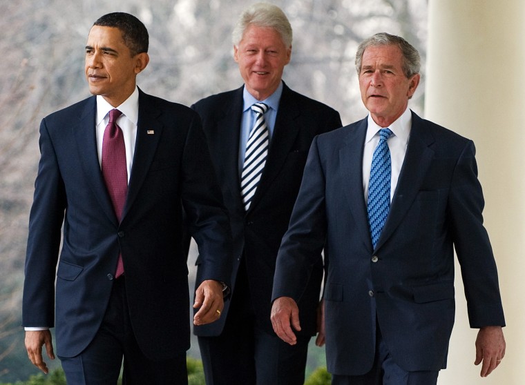 Image: US President Barack Obama (L) walks down