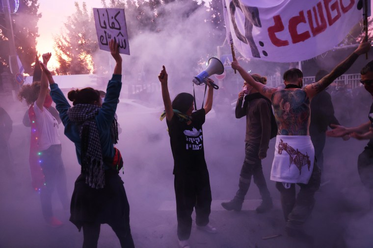 Image: Protesters shout during a demonstration against Israeli Prime Minister Benjamin Netanyahu's alleged corruption, the postponement of his trail and his handling of the Covid-19 crisis outside his residency in Jerusalem on Tuesday.