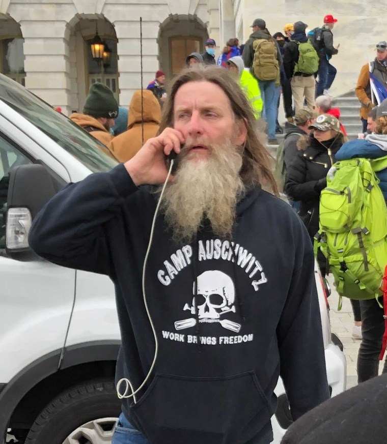 A man wears a "Camp Auschwitz" shirt during protests at the Capitol on Jan. 6, 2021.