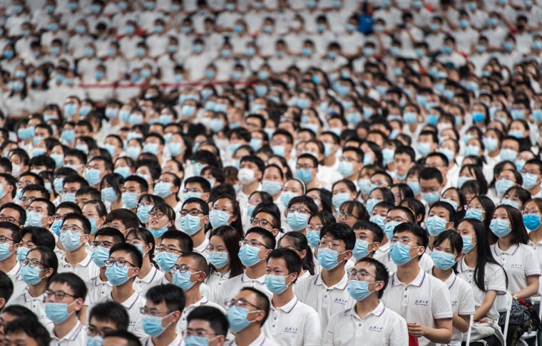 Image: Rows of students wearing masks at commencement ceremony at Wuhan University.
