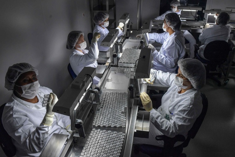 Image: Employees work on the production line of CoronaVac, Sinovac Biotech's vaccine against ovid-19 coronavirus at the Butantan biomedical production center, in Sao Paulo, Brazil
