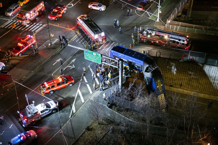 Image: A bus in New York City that careened off a road in the Bronx dangles of an overpass 