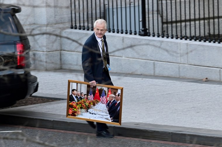Image: White House advisor Navarro leaves the West Wing of the White House with a photograph of U.S. President Trump and Chinese President Xi in Washington