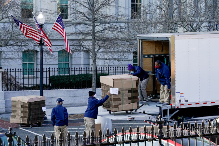 Image: Workers unload pallets of unfolded boxes at the Executive Office Building on the White House grounds in Washington