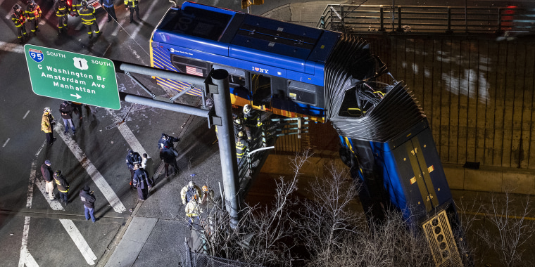 A bus in New York City which careened off a road in the Bronx neighborhood of New York is left dangling from an overpass Friday, Jan. 15, 2021, after a crash late Thursday that left the driver in serious condition, police said.