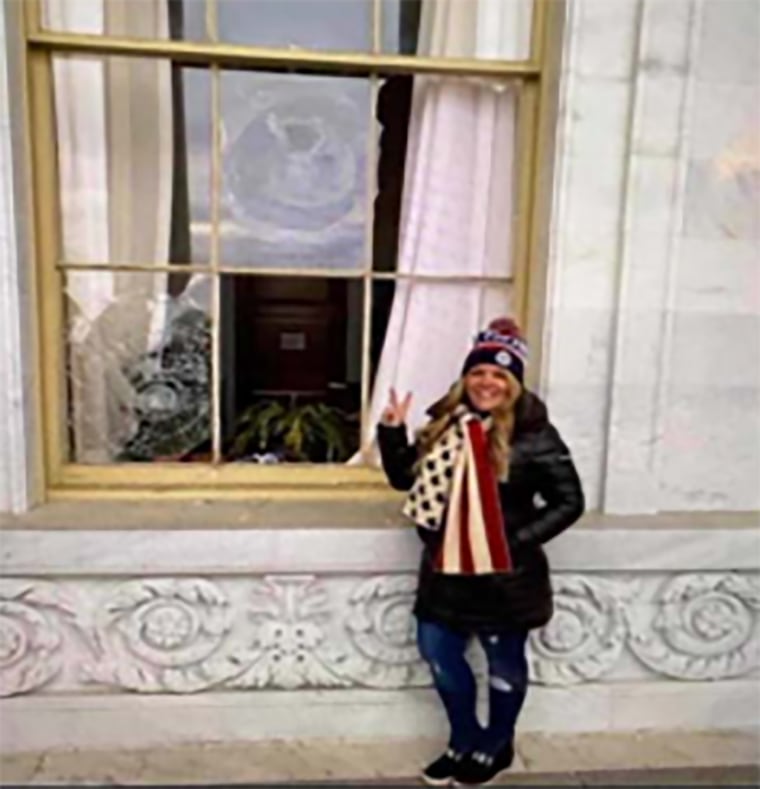 Jenna Ryan in front of a broken window at the U.S. Capitol building.