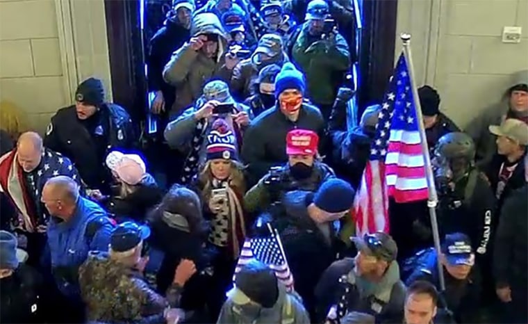 Jenna Ryan, center, looking at her phone while entering the Capitol on Jan. 6, 2021.