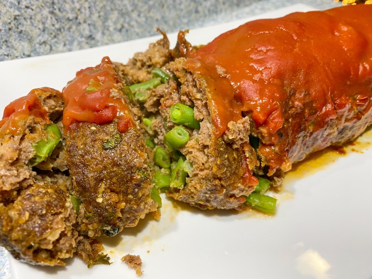 The center of the meatloaf was filled with green beans, while the outer edges were crispy and flavorful.
